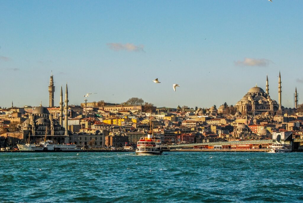 A ferry crossing the Bosphorus with the skyline of Eminönü in Istanbul