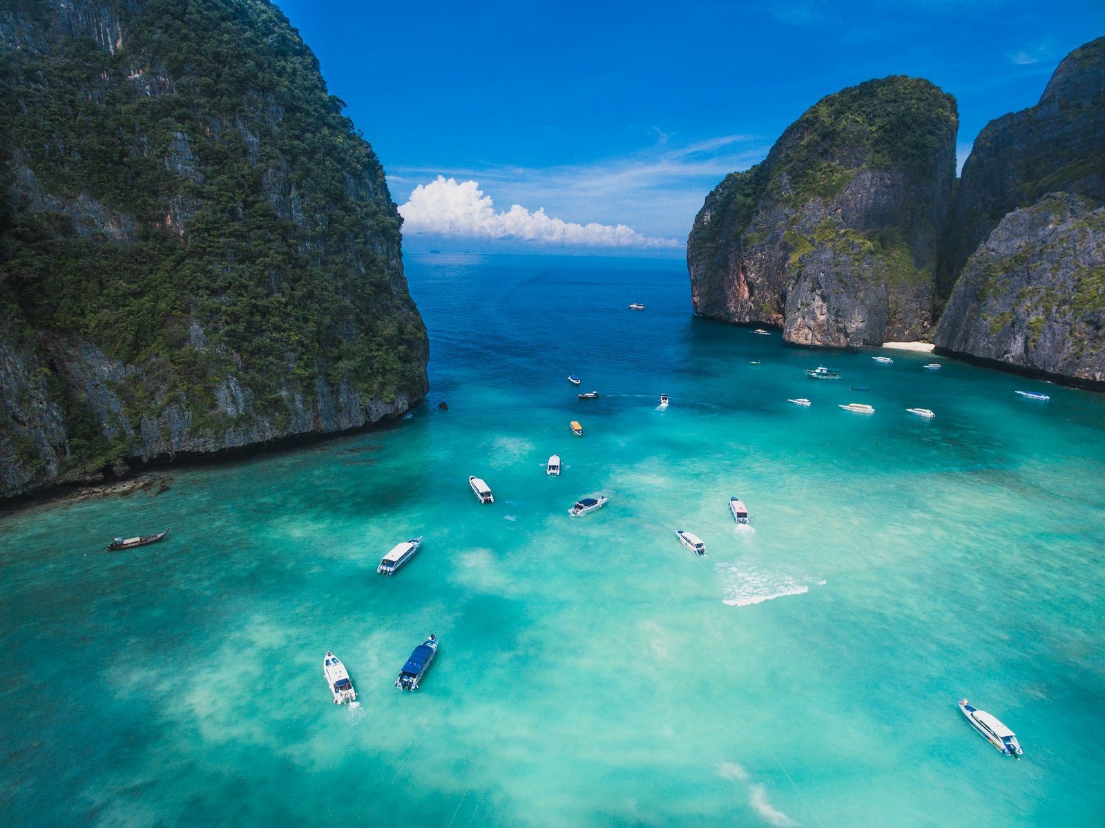 Maya Bay on Phi Phi Leh, a boat trip from Phuket, with clear water and tall cliffs